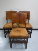 A set of three carved oak dining chairs upholstered in tan leather