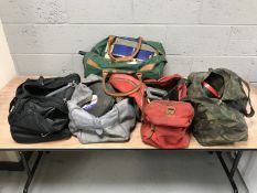 Five holdalls of assorted hand and power tools,