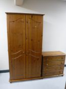 A pine double door wardrobe and a matching four drawer chest