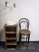 A metal lion mask stick stand together with a set of mahogany open shelves,