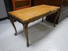 A shaped walnut occasional table on cabriole legs