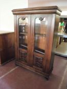 A 20th century oak double glazed door bookcase