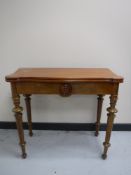 A late 19th century walnut turnover top tea table