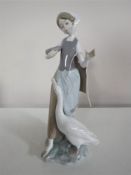A Lladro figure of a girl feeding a goose