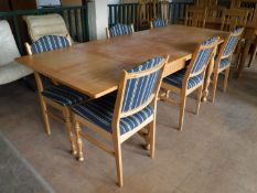 A blonde oak extending table and six chairs