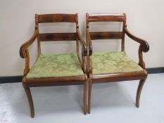 A pair of mahogany scroll-arm armchairs