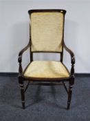 A mahogany armchair upholstered in a gold fabric