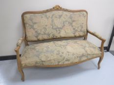 An antique carved framed settee upholstered in a floral fabric CONDITION REPORT:
