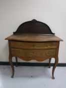An oak serpentine front two drawer chest on shaped legs