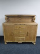An early 20th century carved oak sideboard