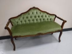 An Italianate window seat upholstered in a green button fabric