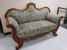 A mahogany framed scroll arm settee