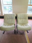 A pair of late 20th century relaxer chairs with cream leather cushions