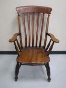 An antique elm kitchen armchair