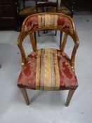 An oak elbow chair in striped fabric