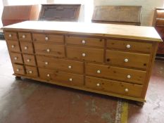 A bank of eighteen pine drawers