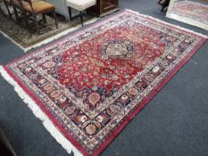 A Persian Kashan design carpet on red ground,