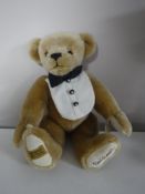 A Merrythought golden mohair bear - Signed David Emanuel, length 35 cm.