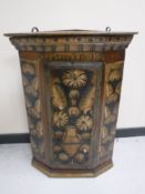 An early 19th century hand painted hanging corner cabinet
