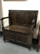 An Edwardian oak hall seat, width 91.