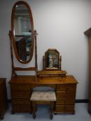 A pine eight drawer knee hole dressing table with mirror and stool plus a cheval mirror