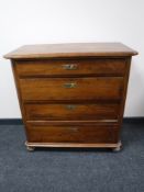 A 19th century mahogany four drawer chest on bun feet
