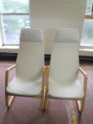 A pair of beech framed high backed armchairs