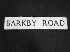 A metal street sign - Barkby road