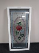 A UPVC framed stained leaded glass window