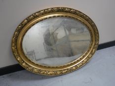 An early 20th century oval gilt framed bevelled edge mirror