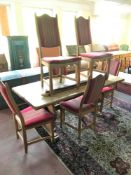 An early 20th century oak refectory table and six blonde oak dining chairs