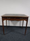 A Victorian inlaid mahogany writing table with green inset panel
