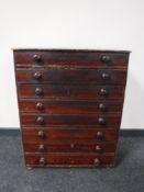 An antique pine eight drawer chest