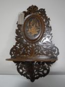 A Victorian inlaid mahogany fretwork wall shelf