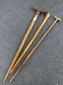 An antique walking cane with French monocle handle together with carved walking stick and Alpine