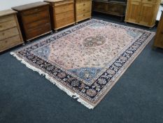 A fringed machine made floral carpet on pink ground