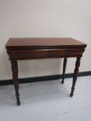 A 19th century mahogany turnover top tea table fitted a drawer