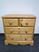 A pine four drawer chest