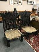 A pair of Arabic hardwood seats, width 70 cm .