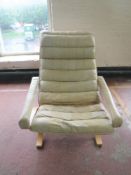 A late 20th century beech framed cream leather armchair