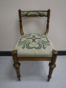 A 19th century mahogany dressing table chair upholstered in a tapestry fabric