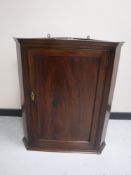 A 19th century inlaid mahogany hanging corner cupboard