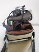 A Canon EOS 500 camera with two lenses together with a camera case