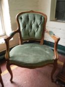 A French walnut framed armchair in green button dralon