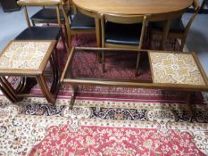 A nest of three teak G Plan tables and a G Plan tiled and glass topped coffee table