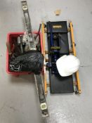 A crate of hand tools, a spirit level, hard hat,