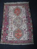 A fringed Eastern rug of geometric design