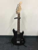 A Burnwood electric guitar on stand