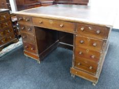A Victorian mahogany leather topped writing desk fitted nine drawers