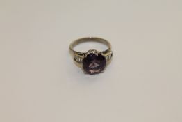 An 18ct white gold Alexandrite ring, a brilliant cut Alexandrite within a claw setting,